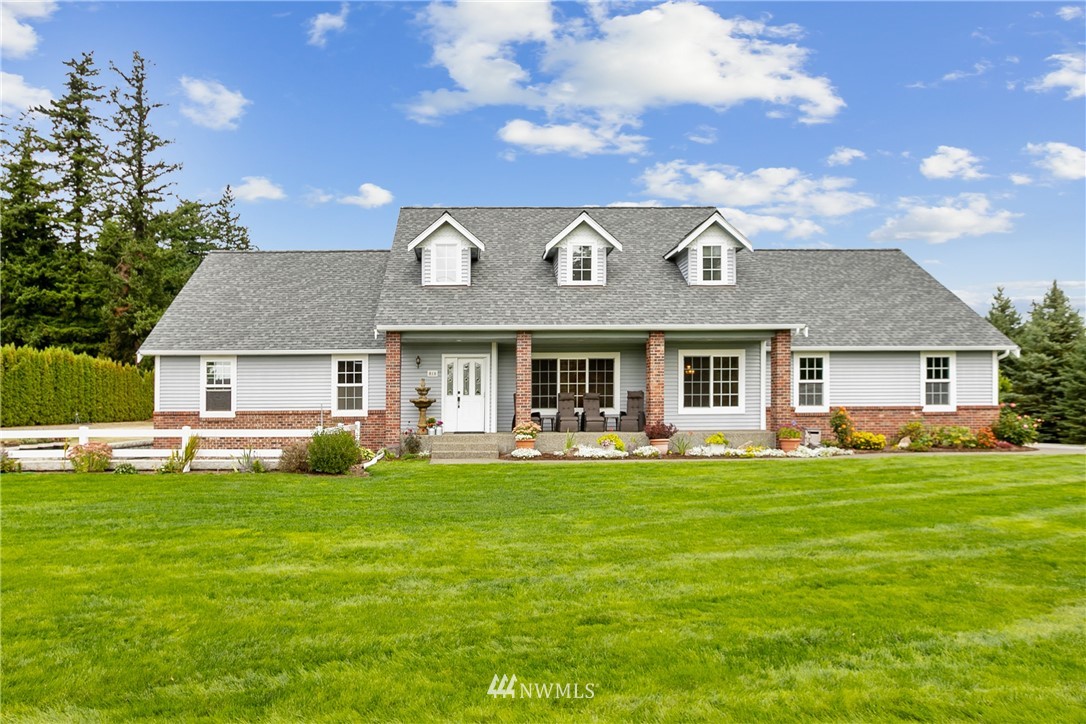 810 East Wiser Lake Road Lynden, WA 98264 - Photo 3 of 40 a front view of a house with a garden and plants