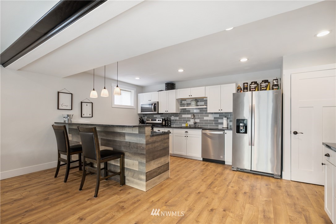 810 East Wiser Lake Road Lynden, WA 98264 - Photo 24 of 40 a kitchen with refrigerator and wooden floor