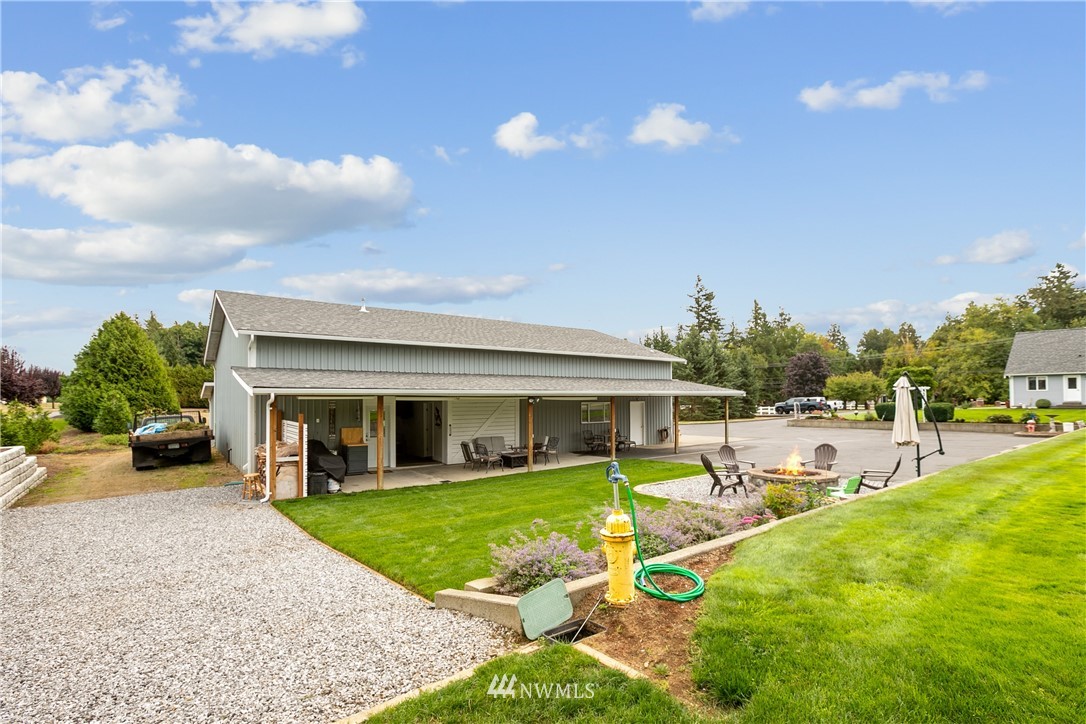 810 East Wiser Lake Road Lynden, WA 98264 - Photo 32 of 40 a view of a house with swimming pool and a yard