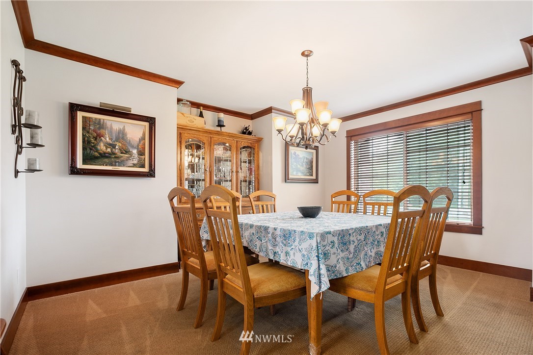 810 East Wiser Lake Road Lynden, WA 98264 - Photo 8 of 40 a dining room with furniture a chandelier and wooden floor
