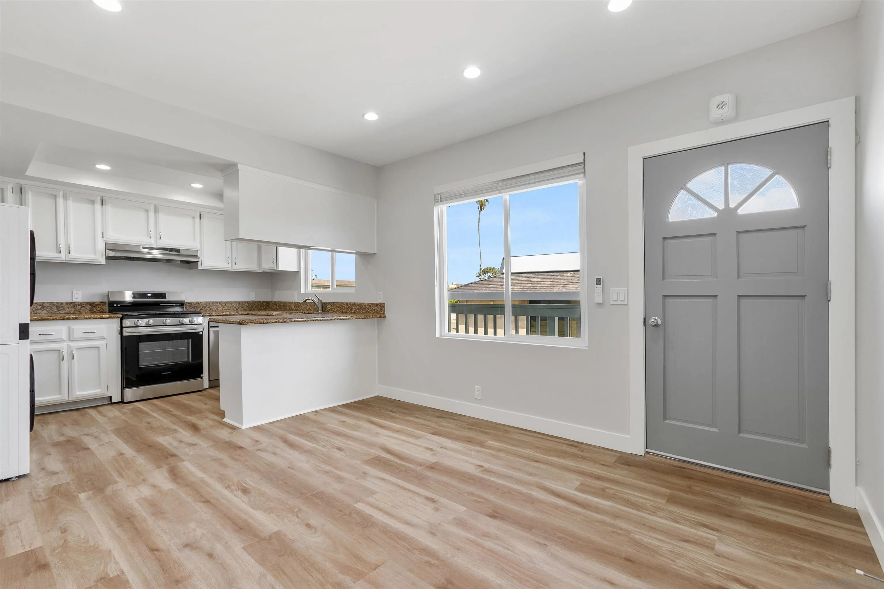 520 Pearl Street, Unit 2 La Jolla, CA 92037 - Photo 3 of 27 a kitchen with granite countertop stainless steel appliances refrigerator sink and cabinets