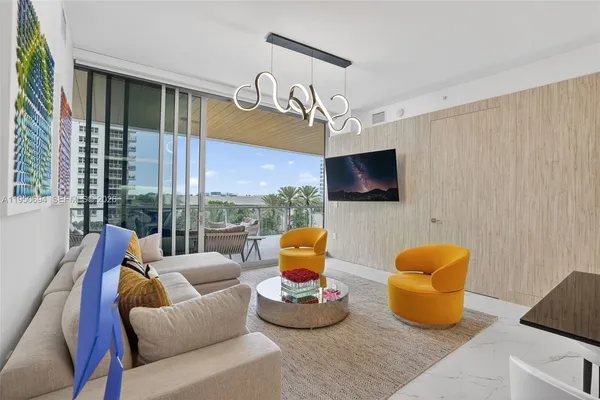 a bedroom with furniture and a flat screen tv