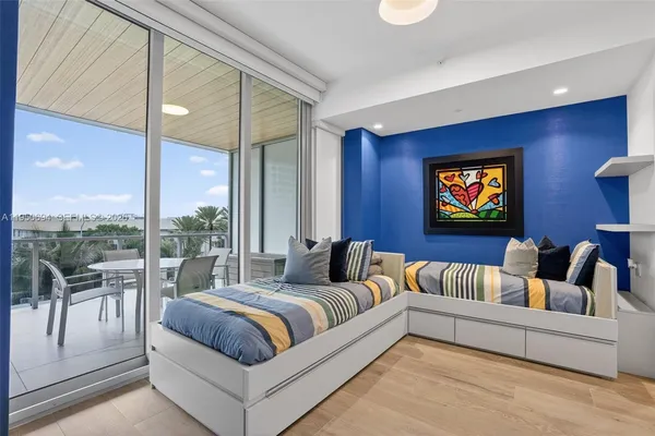 a bedroom with furniture and a large window