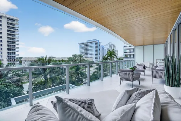 a view of a patio with couches table and chairs and potted plants