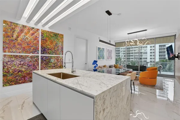 a kitchen with stainless steel appliances granite countertop a sink and a large window