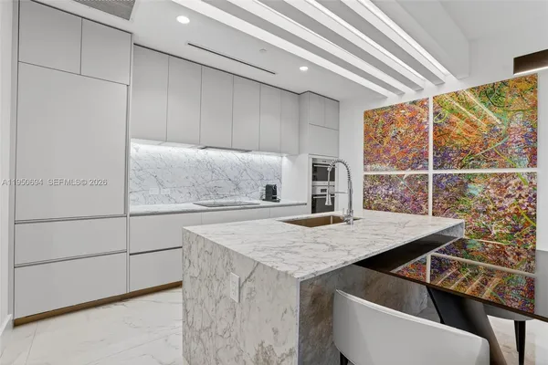 a kitchen with a table chairs and a refrigerator