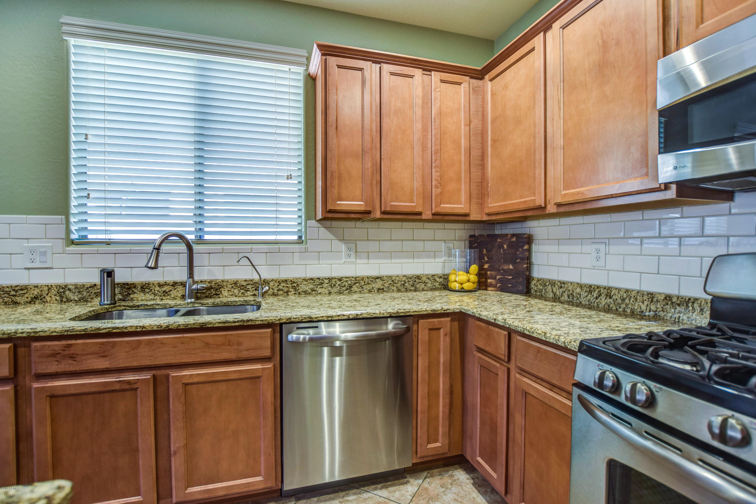 19702 East Thornton Road Queen Creek, AZ 85142 - Photo 20 of 79 a kitchen with granite countertop a sink stainless steel appliances and cabinets