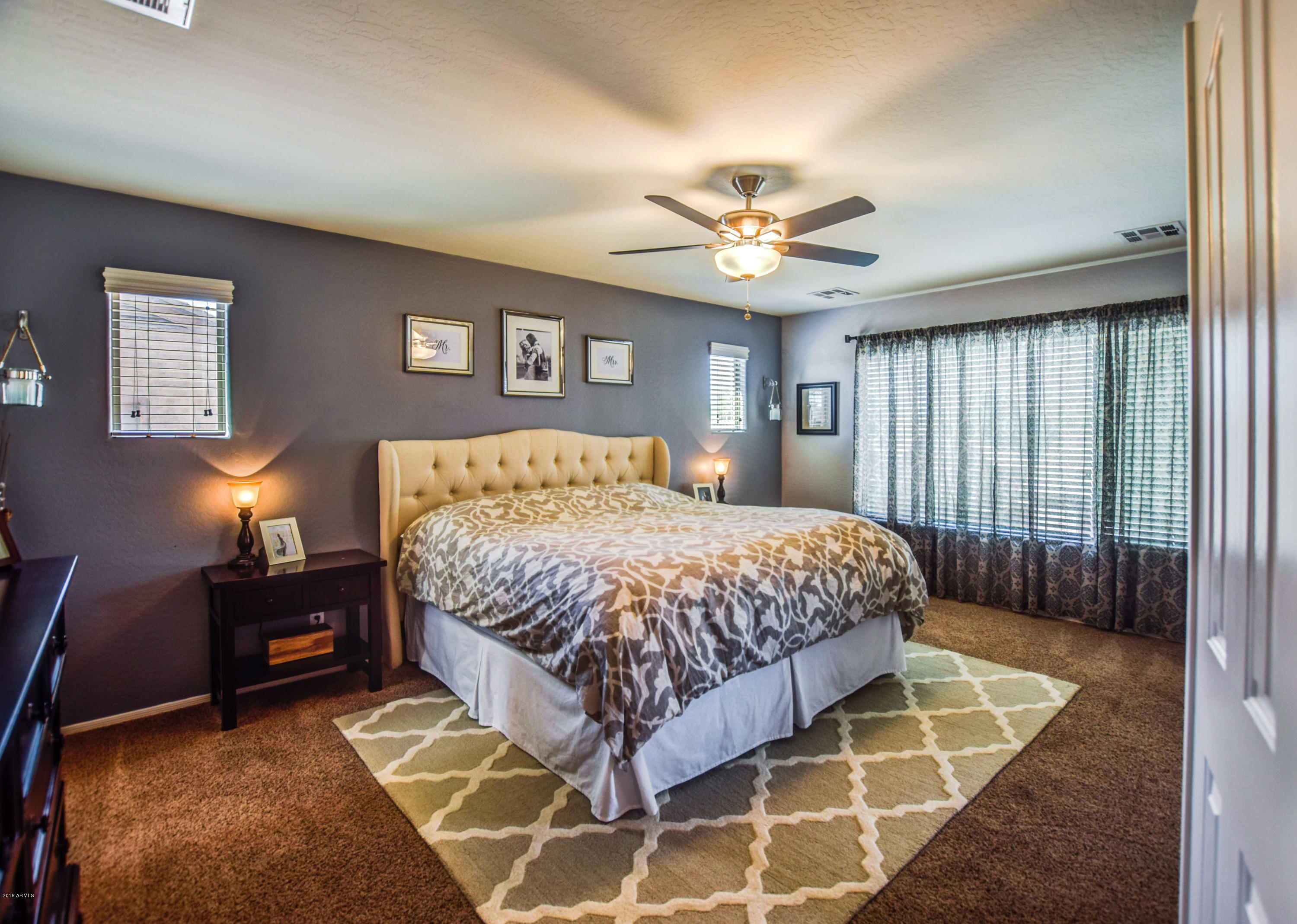 19702 East Thornton Road Queen Creek, AZ 85142 - Photo 32 of 79 a bedroom with a bed and a chandelier