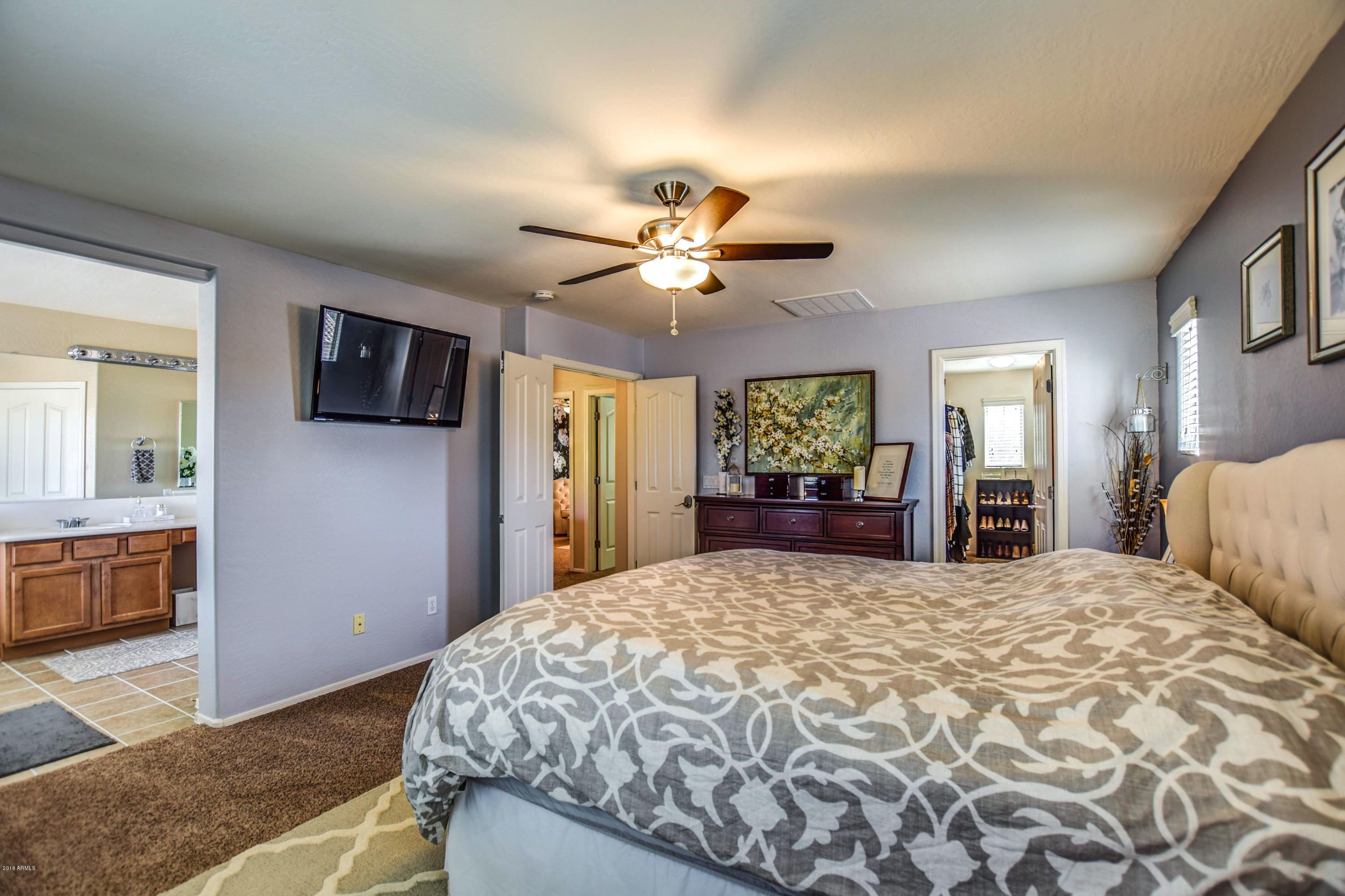 19702 East Thornton Road Queen Creek, AZ 85142 - Photo 35 of 79 a bedroom with a large bed a flat tv screen and dresser