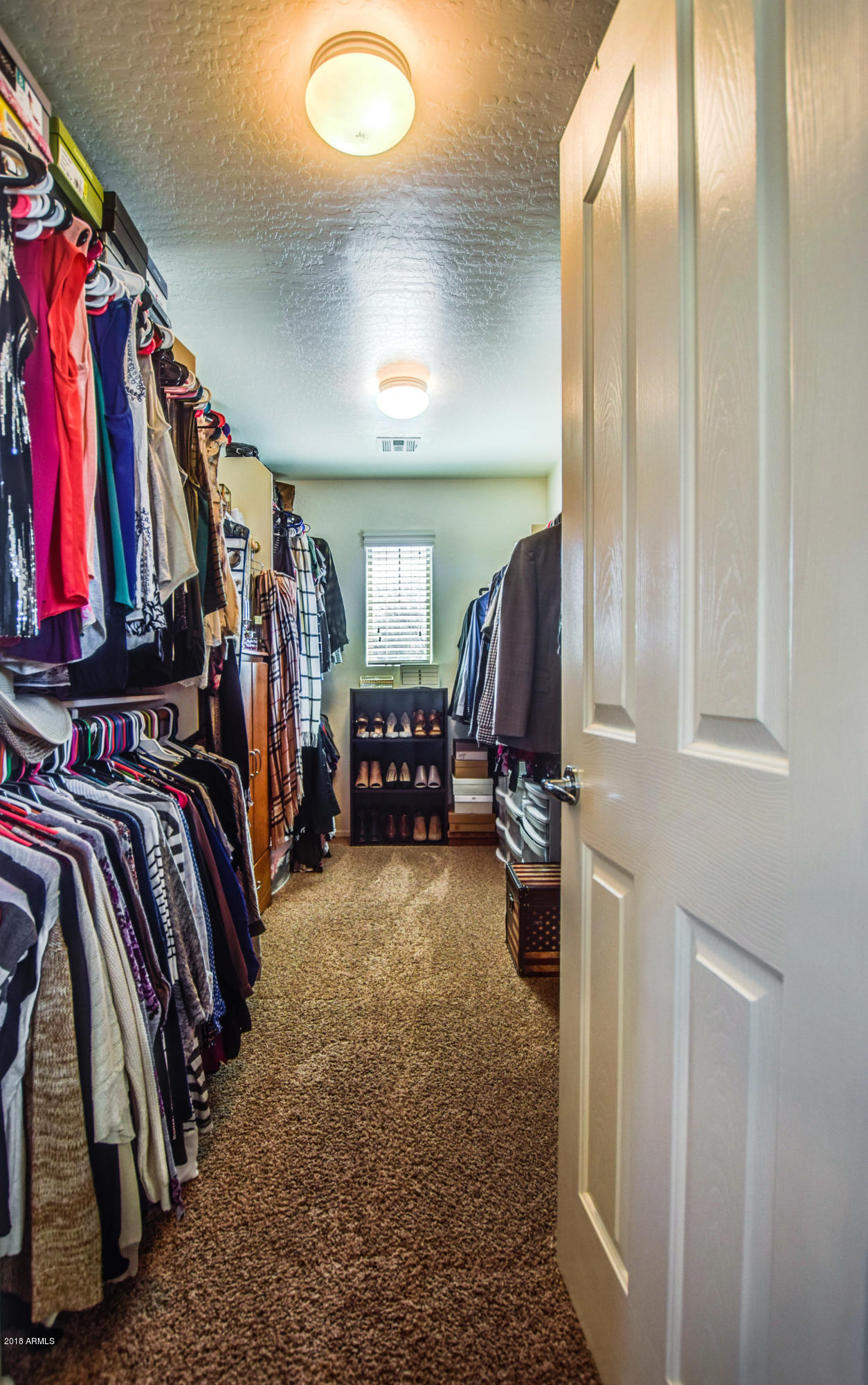 19702 East Thornton Road Queen Creek, AZ 85142 - Photo 42 of 79 a view of walk in closet with clothes and shoes
