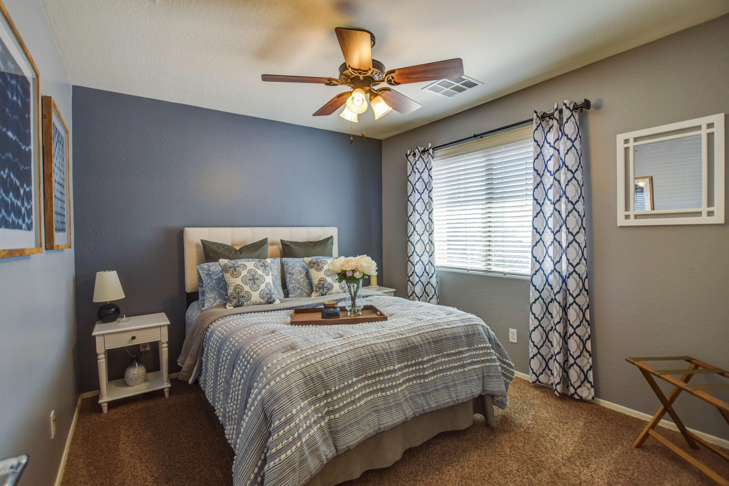 19702 East Thornton Road Queen Creek, AZ 85142 - Photo 46 of 79 a bedroom with a bed and a chandelier