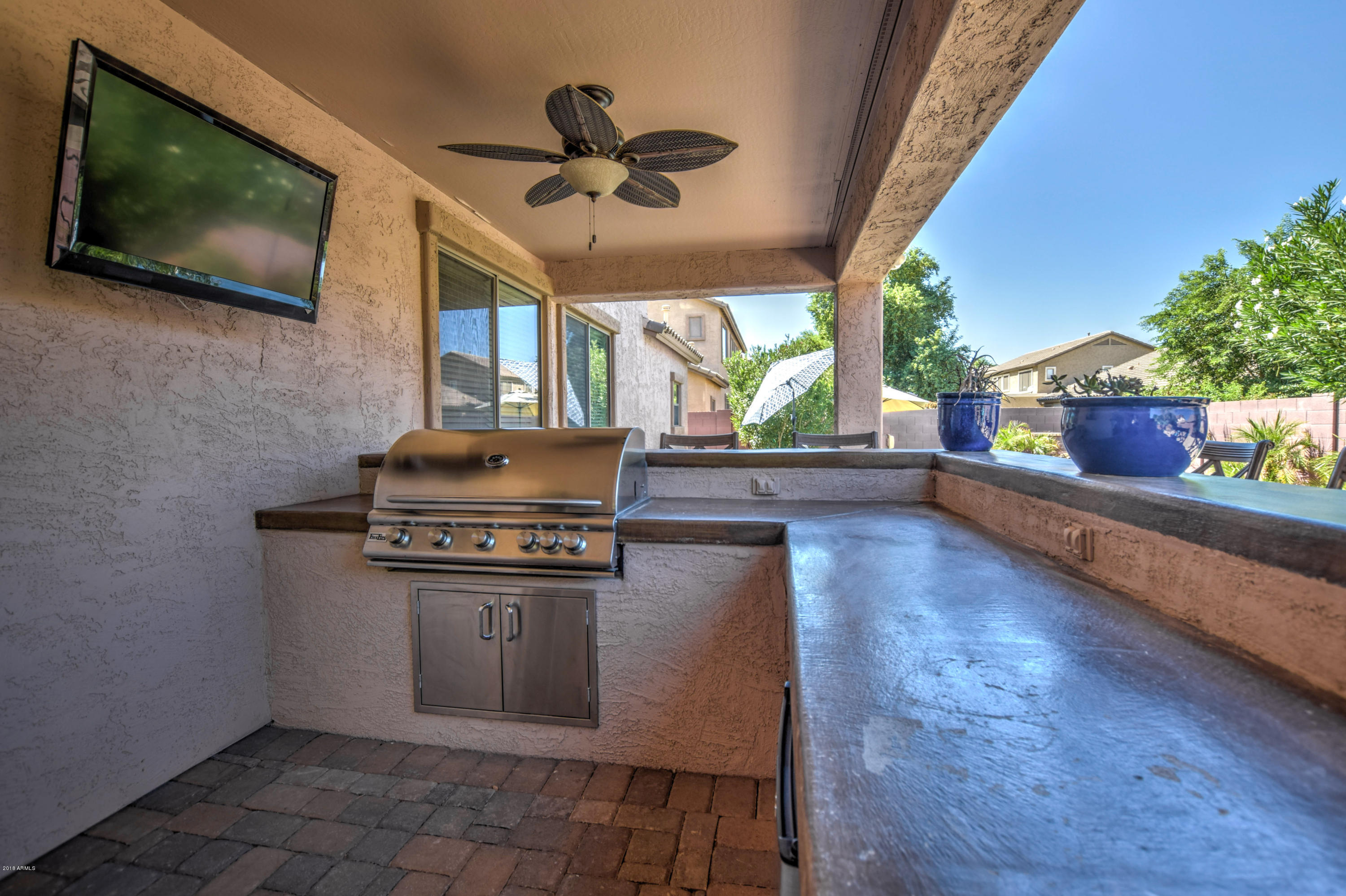 19702 East Thornton Road Queen Creek, AZ 85142 - Photo 62 of 79 a kitchen with stainless steel appliances granite countertop a stove a sink dishwasher and a microwave oven with cabinets