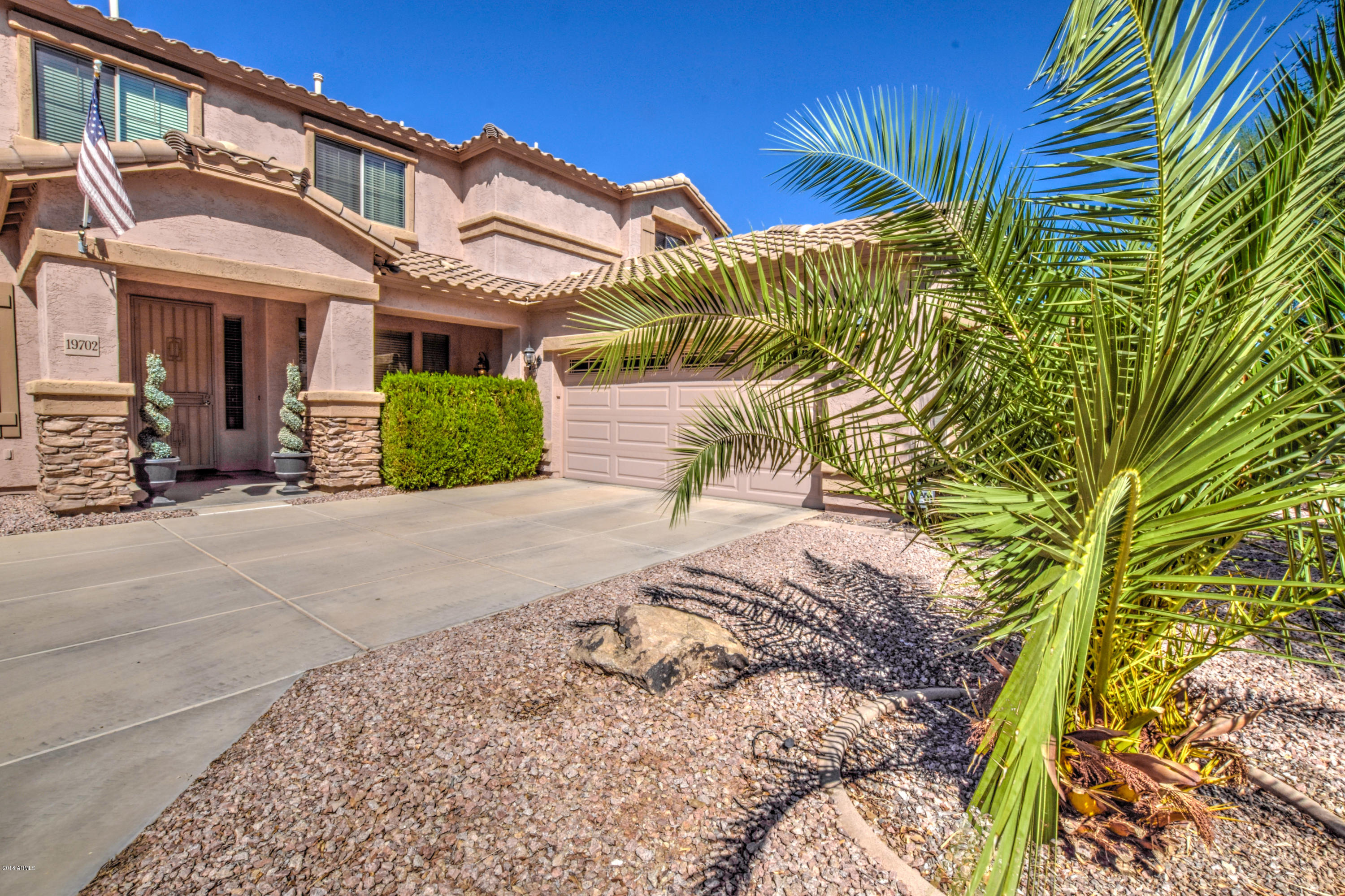 19702 East Thornton Road Queen Creek, AZ 85142 - Photo 79 of 79 a view of a white house with a yard and potted plants