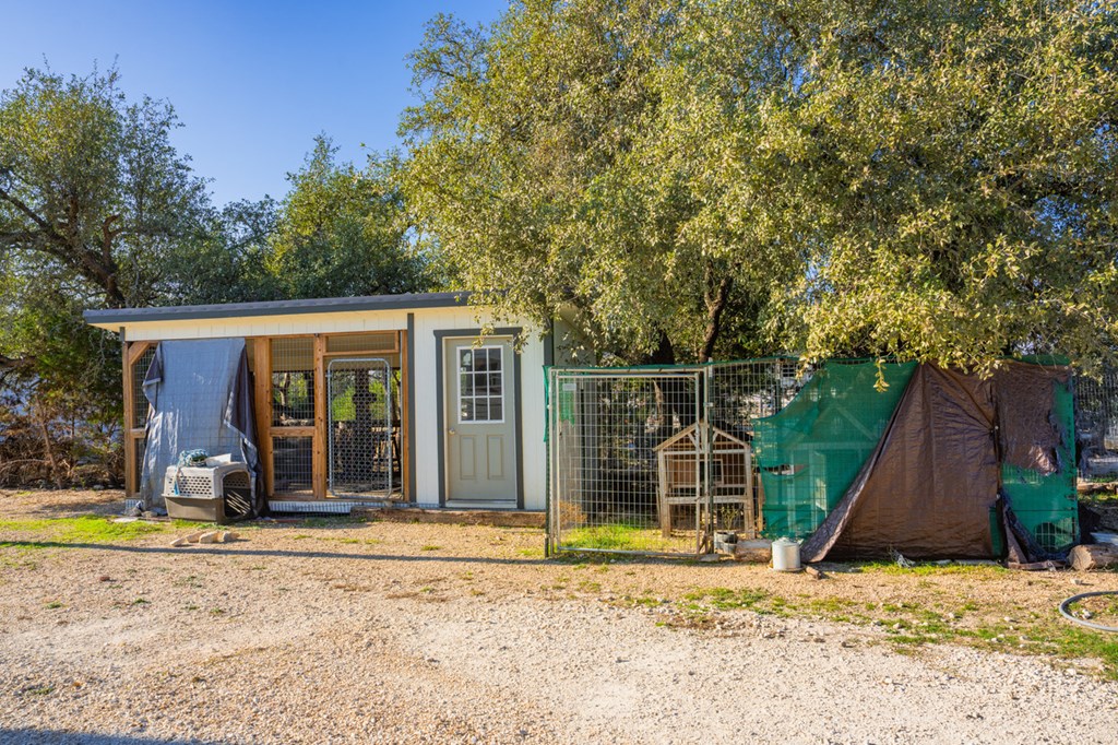 1031 Ranch To Market 479 Mountain Home, TX 78058 - Photo 15 of 22 a view of a house with backyard and sitting area