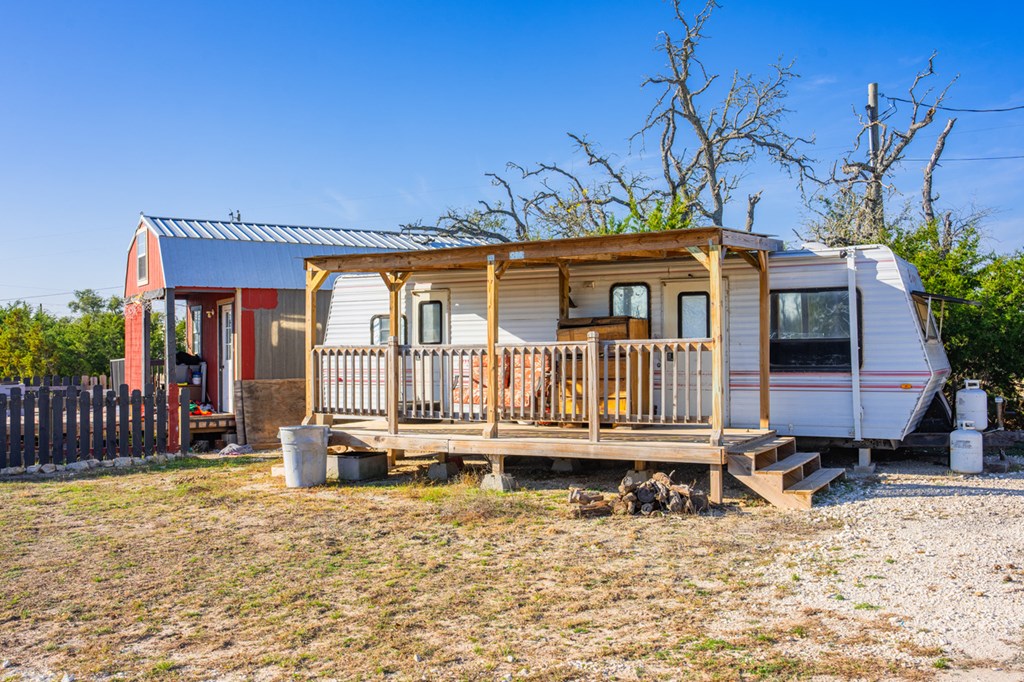 1031 Ranch To Market 479 Mountain Home, TX 78058 - Photo 17 of 22 a view of a house with a wooden deck