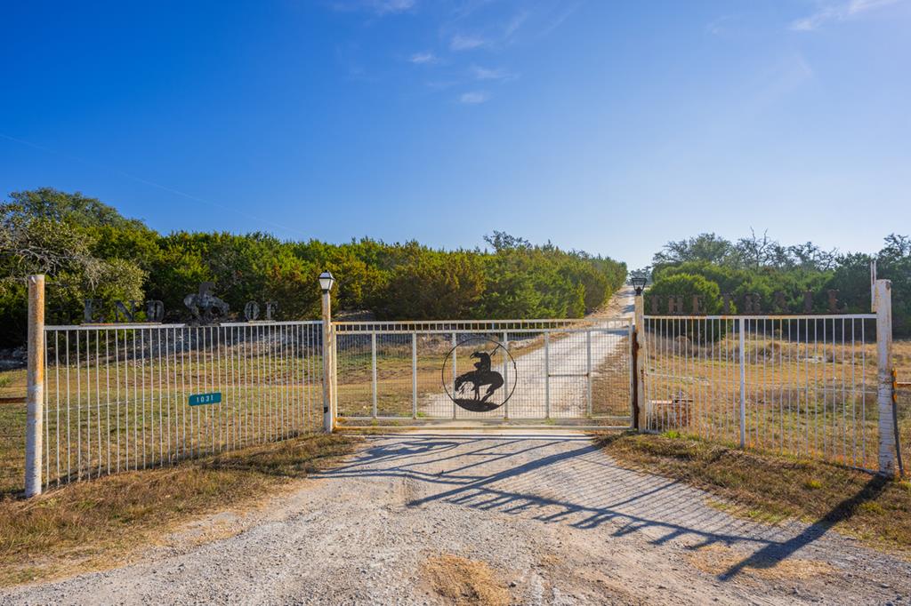 1031 Ranch To Market 479 Mountain Home, TX 78058 - Photo 4 of 22 a view of a wooden deck with a white fence