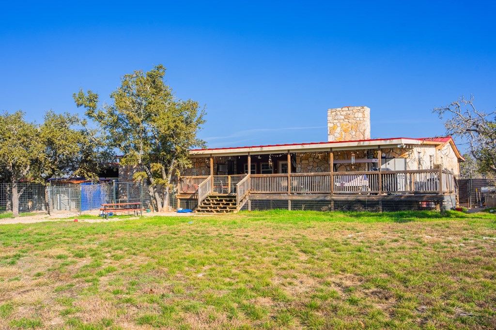 1031 Ranch To Market 479 Mountain Home, TX 78058 - Photo 7 of 22 a backyard of a house with table and chairs