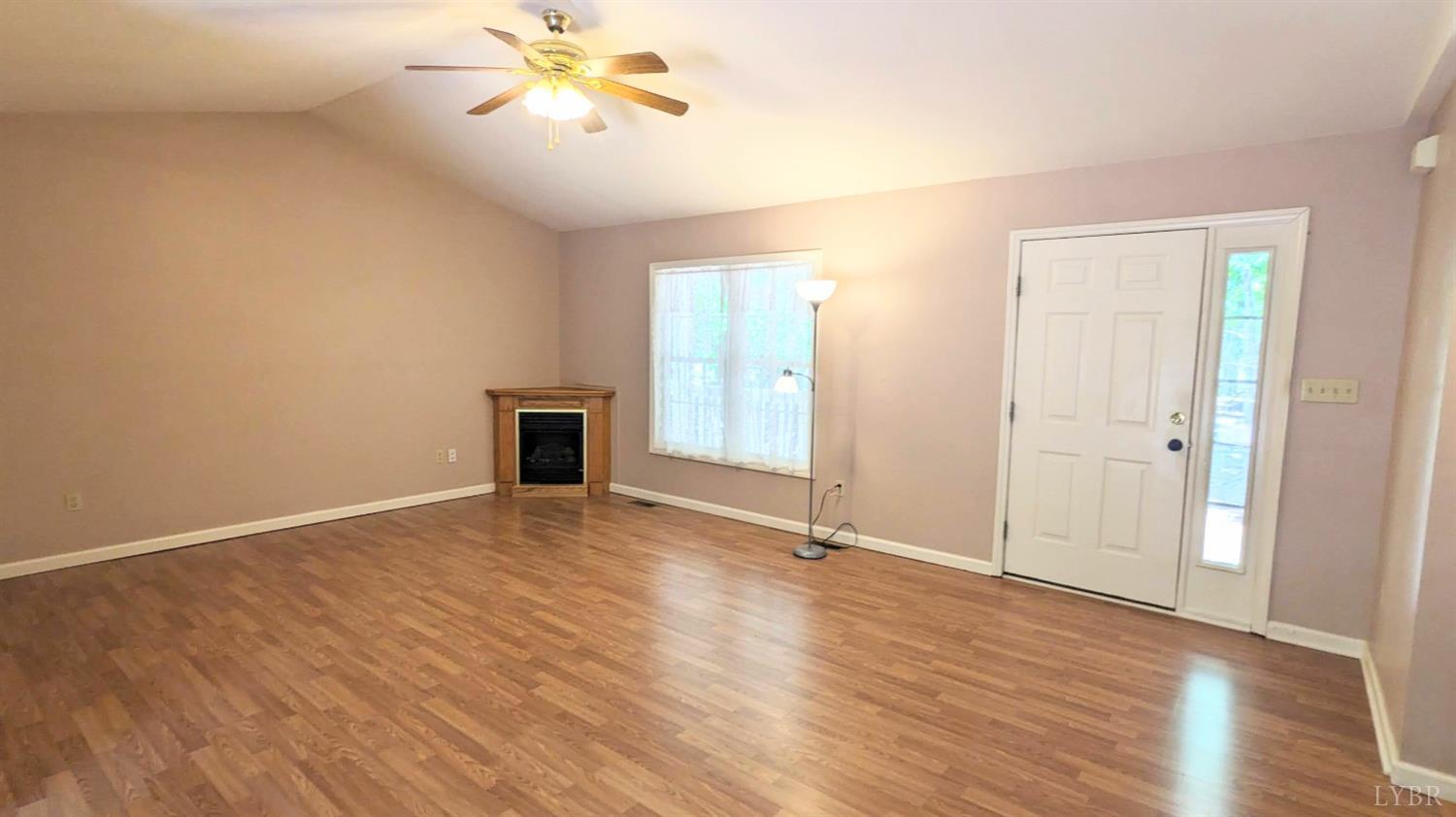 3959 Diamond Hill Road Moneta, VA 24121 - Photo 11 of 50 a view of an empty room with wooden floor and a ceiling fan