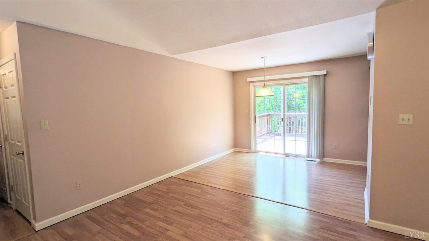 3959 Diamond Hill Road Moneta, VA 24121 - Photo 15 of 50 an empty room with wooden floor and windows