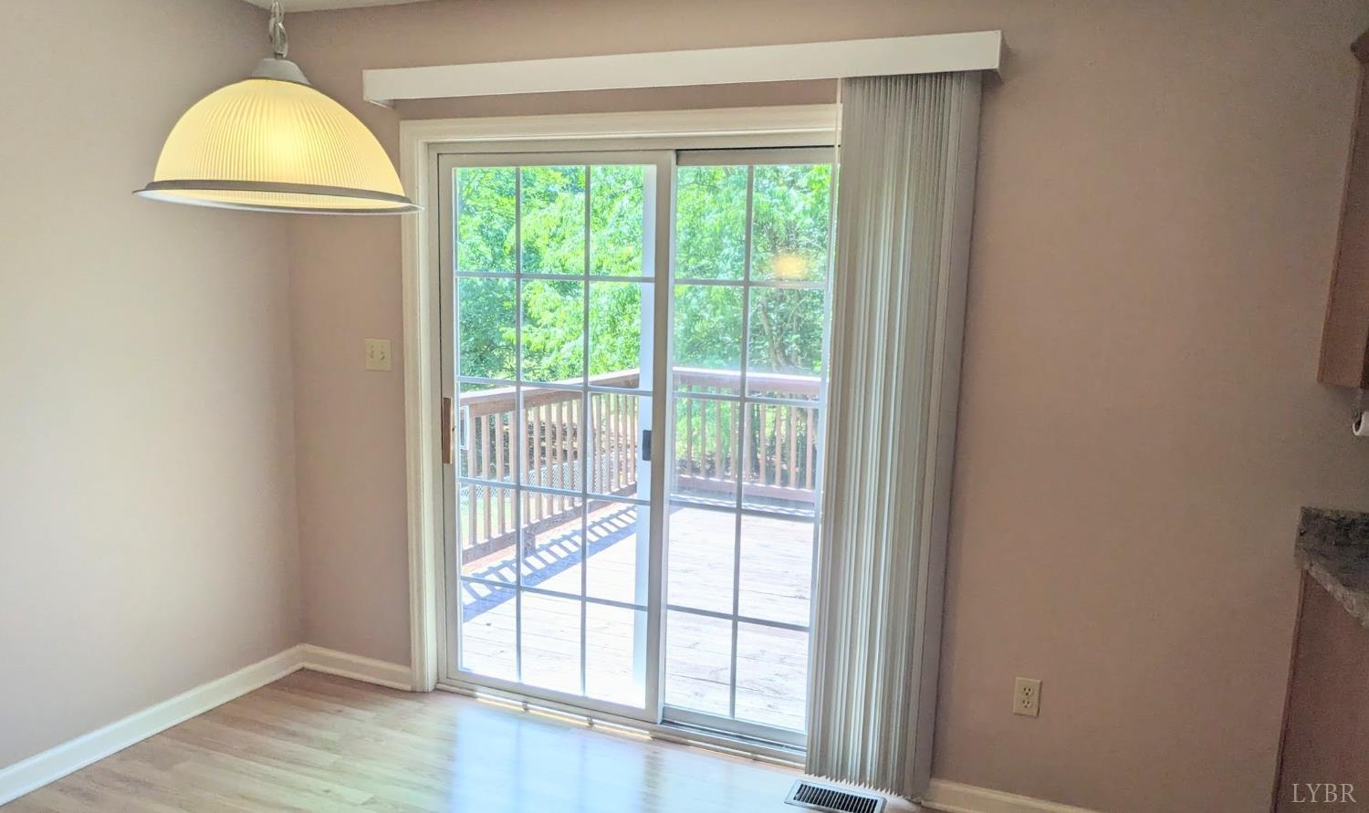 3959 Diamond Hill Road Moneta, VA 24121 - Photo 16 of 50 an empty room with wooden floor and windows