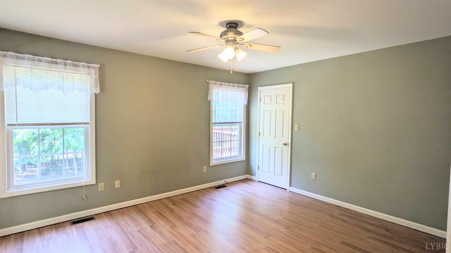 3959 Diamond Hill Road Moneta, VA 24121 - Photo 20 of 50 an empty room with wooden floor and windows