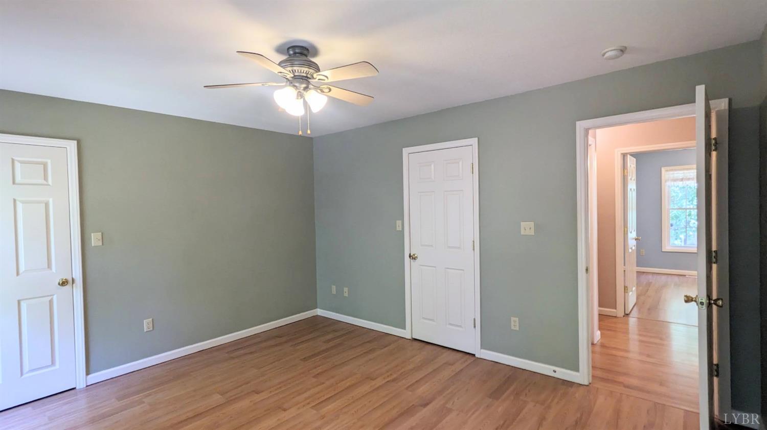 3959 Diamond Hill Road Moneta, VA 24121 - Photo 21 of 50 a view of an empty room with wooden floor and a ceiling fan