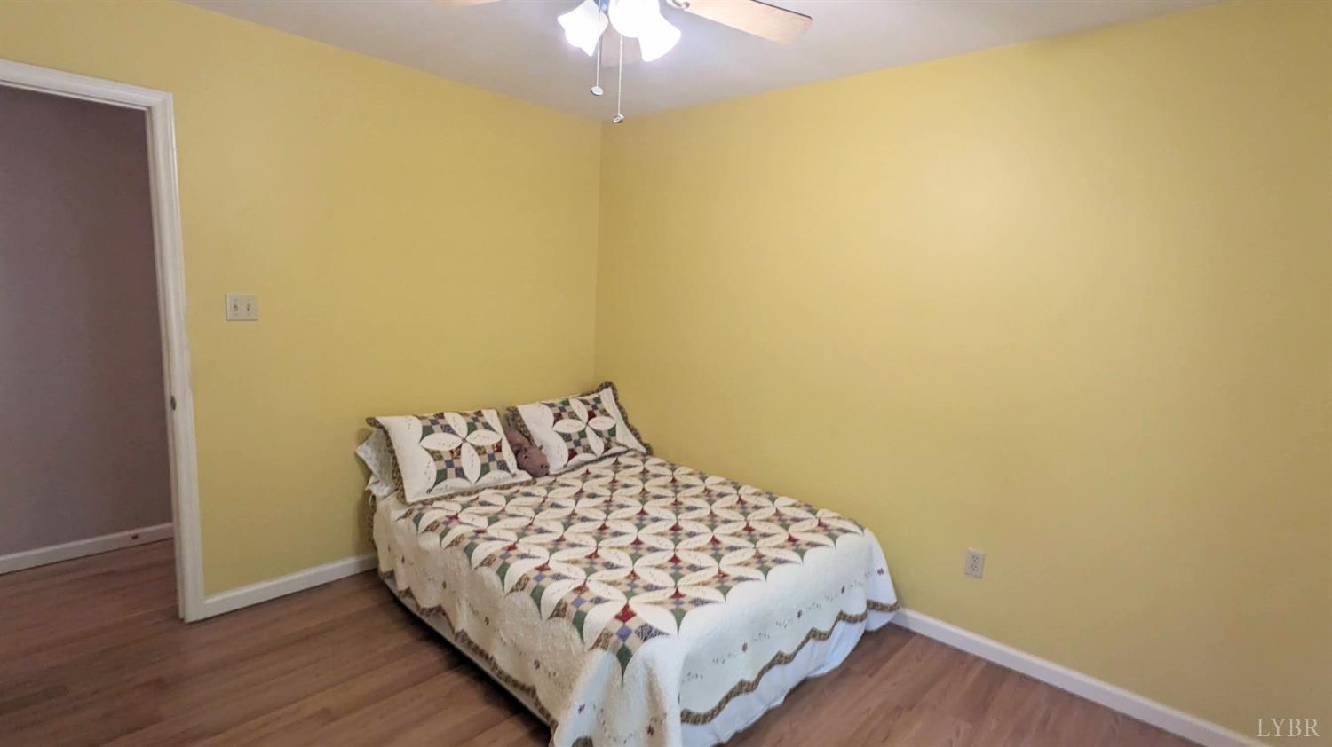 3959 Diamond Hill Road Moneta, VA 24121 - Photo 29 of 50 a bedroom with a bed and wooden floor