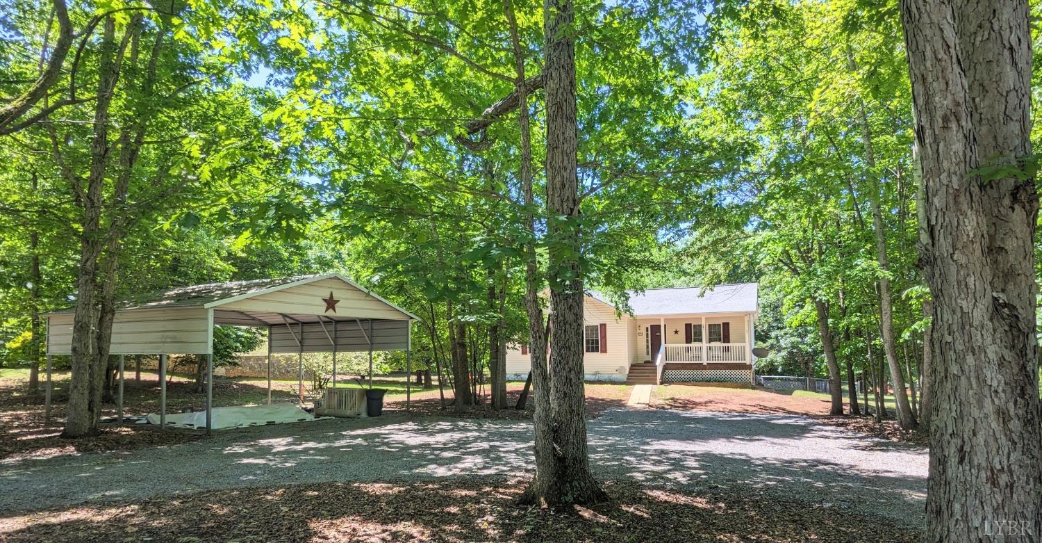 3959 Diamond Hill Road Moneta, VA 24121 - Photo 3 of 50 a front view of a house with a garden