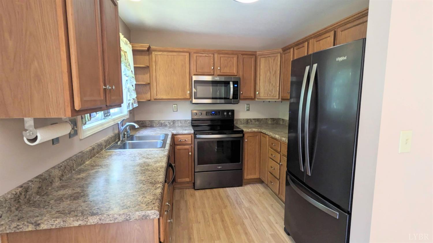 3959 Diamond Hill Road Moneta, VA 24121 - Photo 8 of 50 a kitchen with a refrigerator stove and microwave