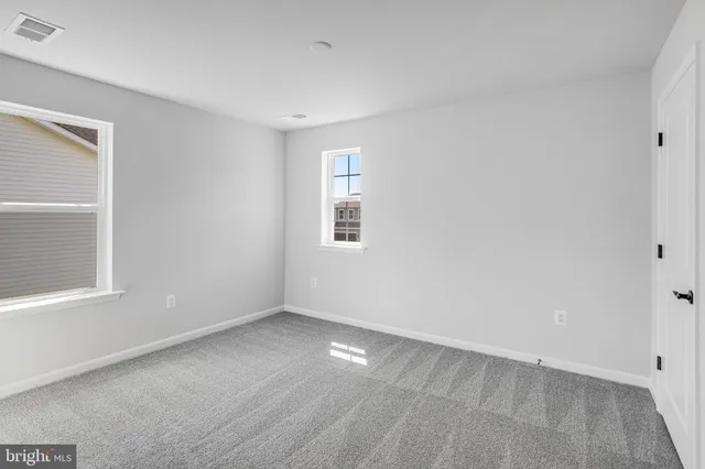 a view of an empty room and a window