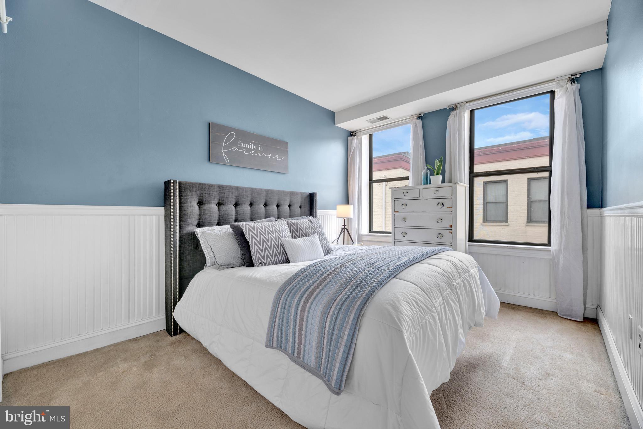 1436 W Street Northwest, Unit 405 Washington, DC 20009 - Photo 12 of 13 a bed room with a bed and a large window
