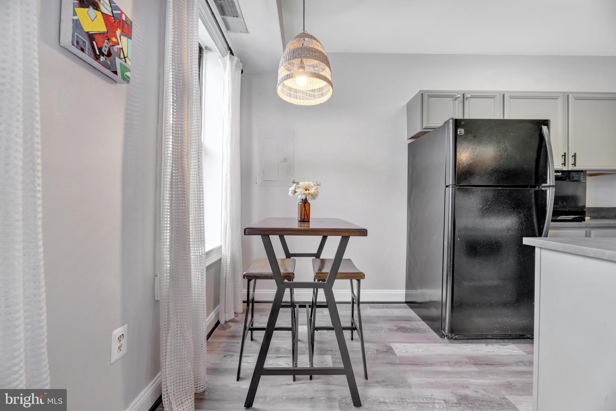 1436 W Street Northwest, Unit 405 Washington, DC 20009 - Photo 4 of 13 a kitchen with a refrigerator and a table in it