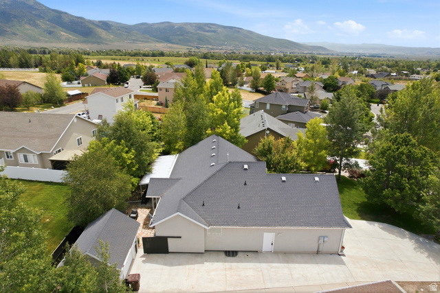 5196 Rodeo Circle Oakley, UT 84055 - Photo 57 of 57 Aerial property perspective featuring a neutral-toned exterior, dark shingled roofs, and an expansive concrete driveway