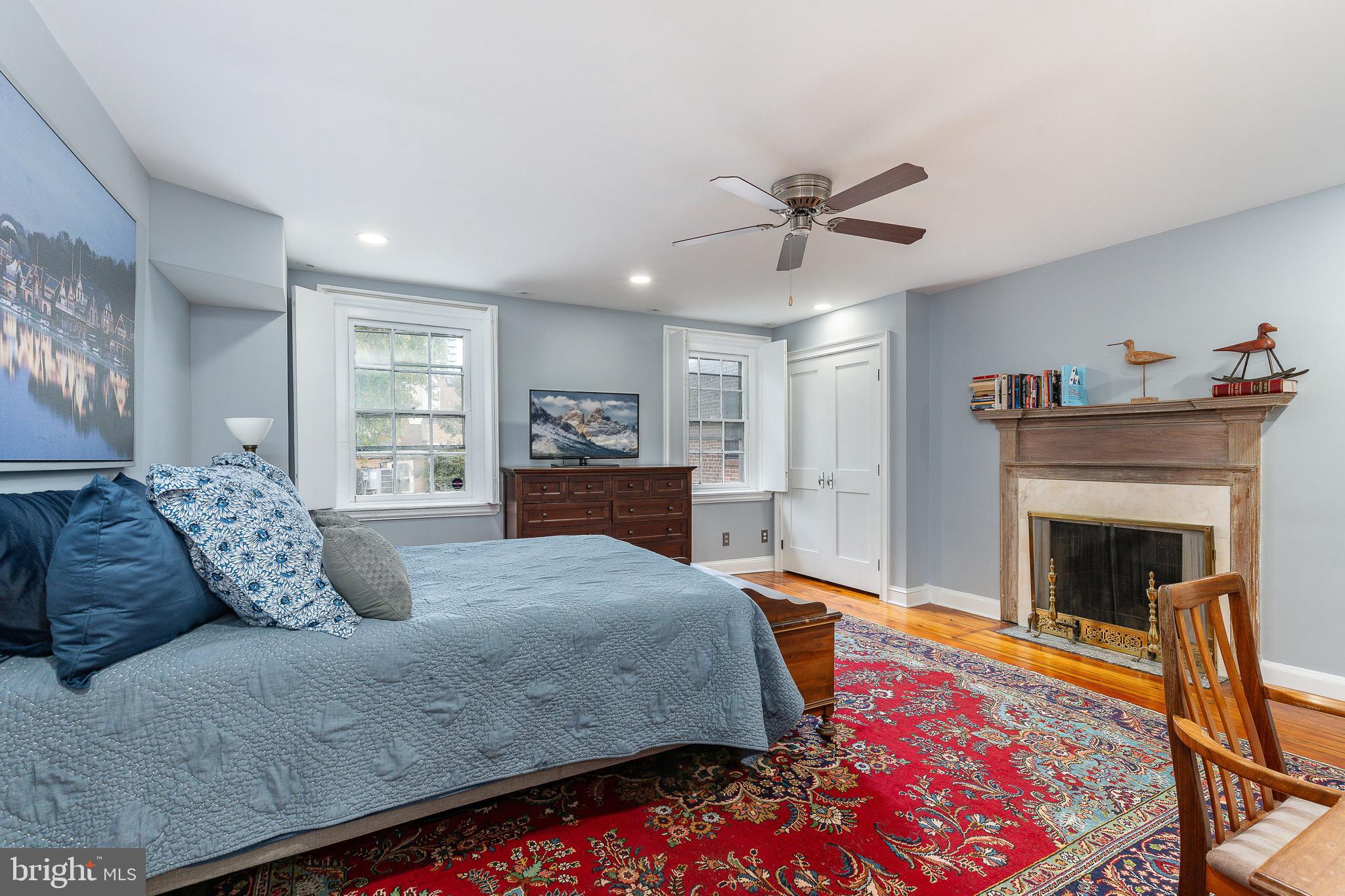 517 Pine Street Philadelphia, PA 19106 - Photo 43 of 63 a bedroom with a large bed and a fireplace