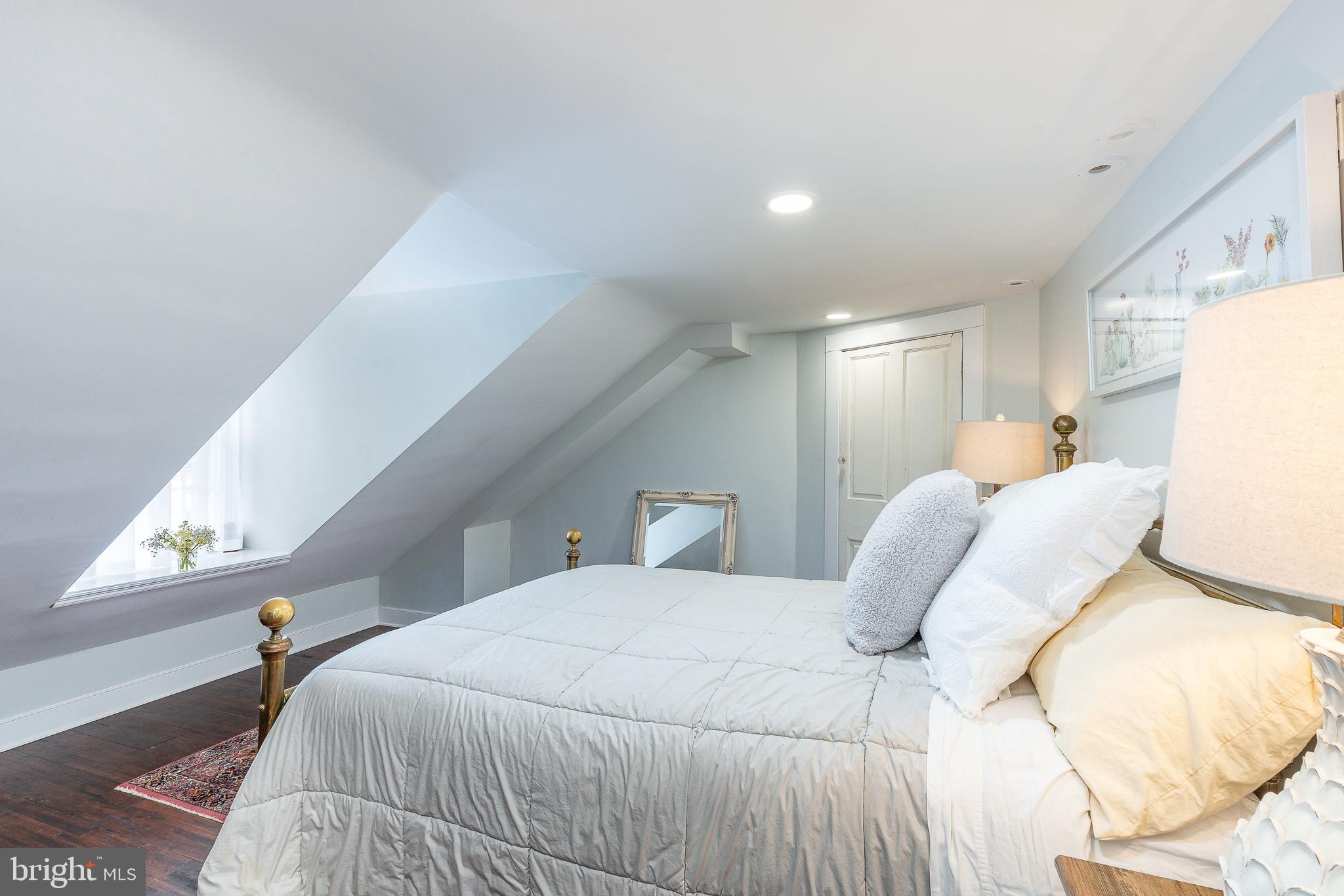 517 Pine Street Philadelphia, PA 19106 - Photo 49 of 63 a bedroom with a bed and a lamp with window
