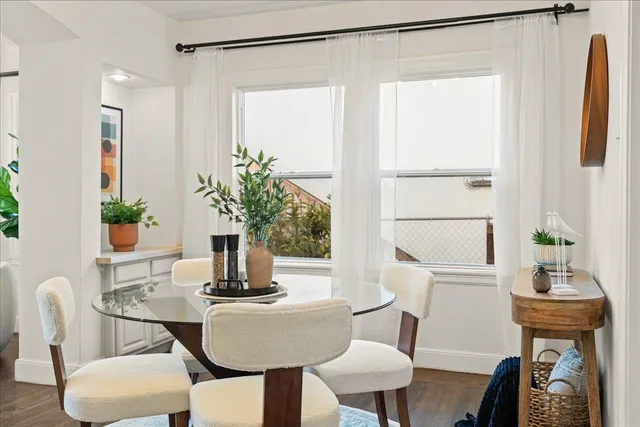 a dining room with furniture and wooden floor