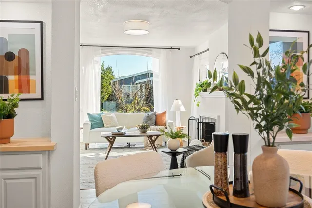 a living room with furniture a chandelier and a fireplace