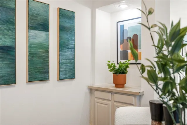 a potted plant sitting on top of a wooden table and chair