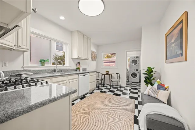 a kitchen with stainless steel appliances kitchen island granite countertop a sink and cabinets