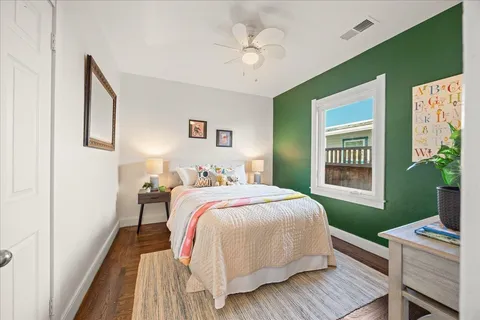 a bedroom with a bed dresser and a window