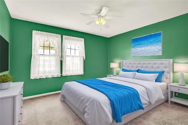 a bedroom with a large bed and a chandelier