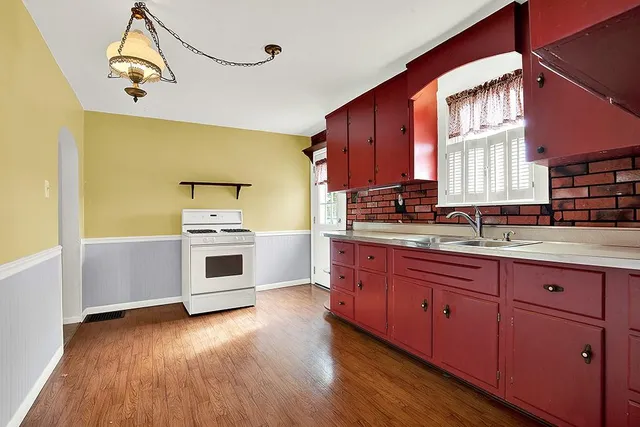 a view of empty room with wooden floor and cabinet
