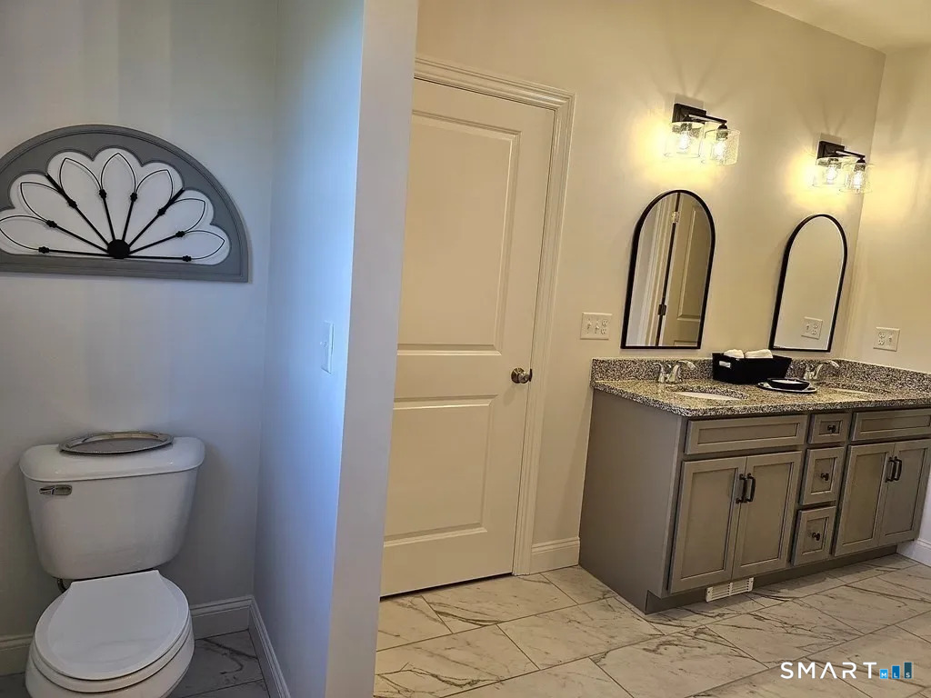 80 Aldrich Road Putnam, CT 06260 - Photo 17 of 23 a bathroom with a toilet sink and mirror