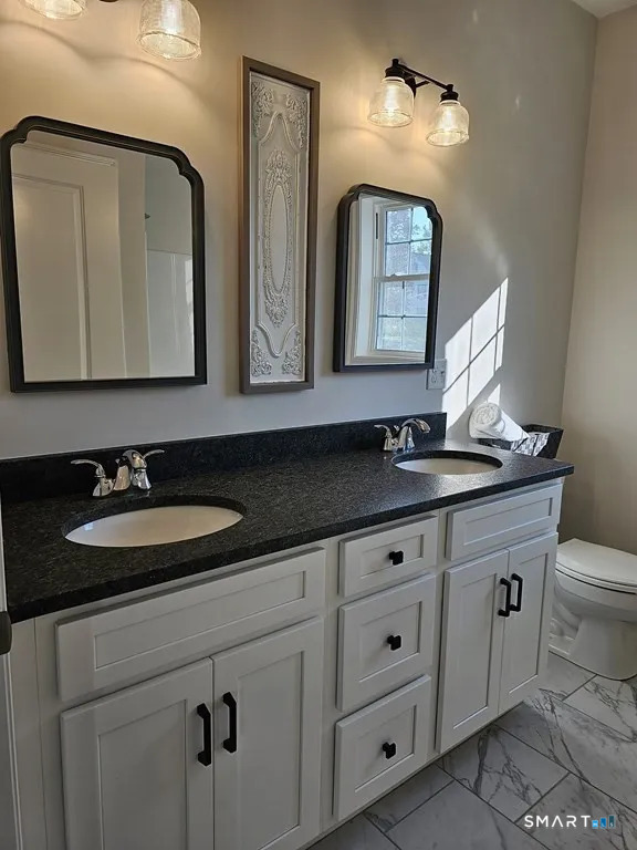 80 Aldrich Road Putnam, CT 06260 - Photo 19 of 23 a bathroom with a double vanity sink and a mirror