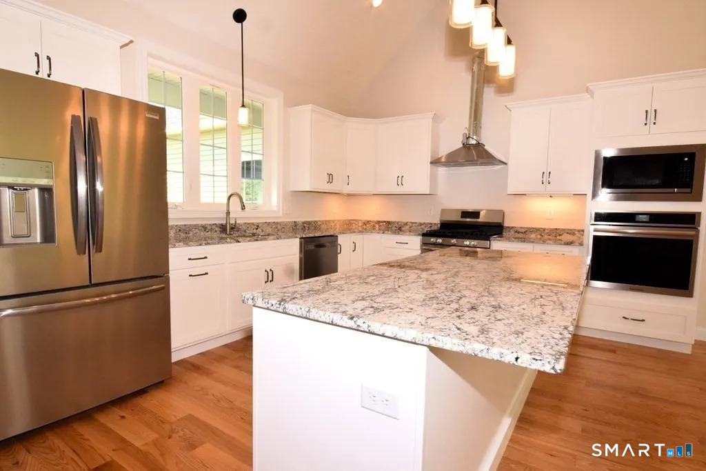 80 Aldrich Road Putnam, CT 06260 - Photo 2 of 23 a kitchen with stainless steel appliances granite countertop a refrigerator a stove a sink dishwasher and a refrigerator with wooden floor