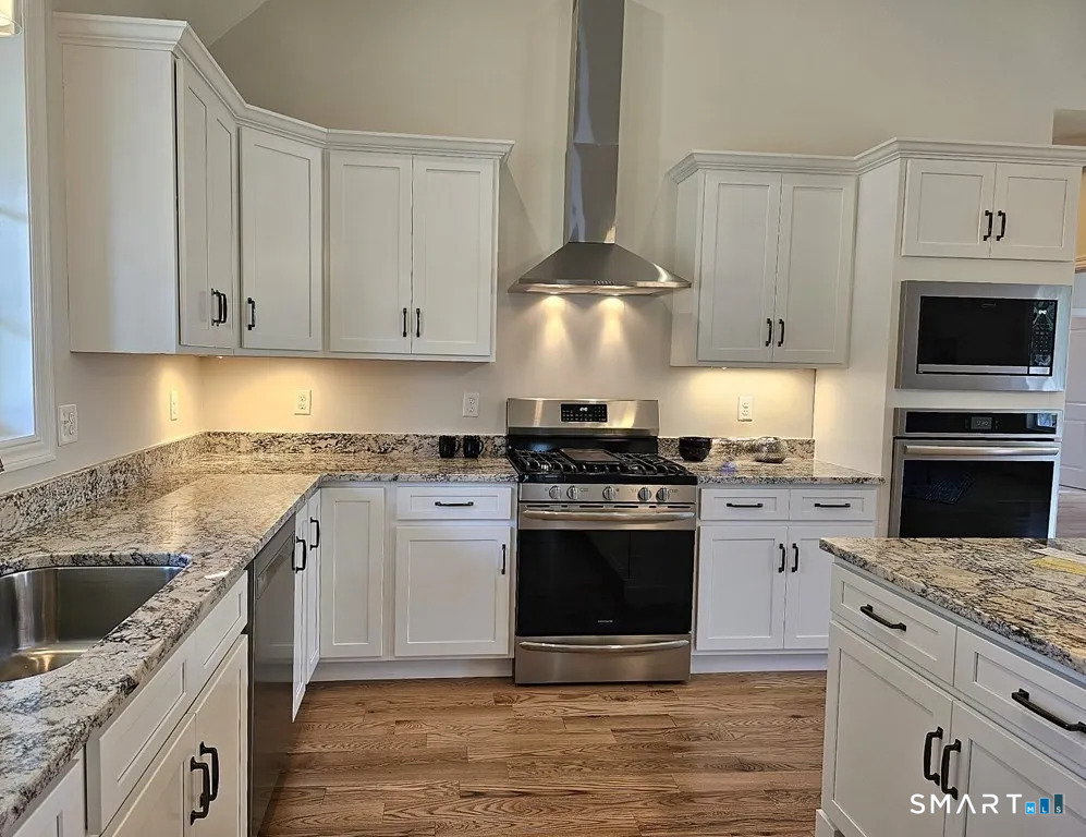 80 Aldrich Road Putnam, CT 06260 - Photo 3 of 23 a kitchen with stainless steel appliances granite countertop a stove and a sink