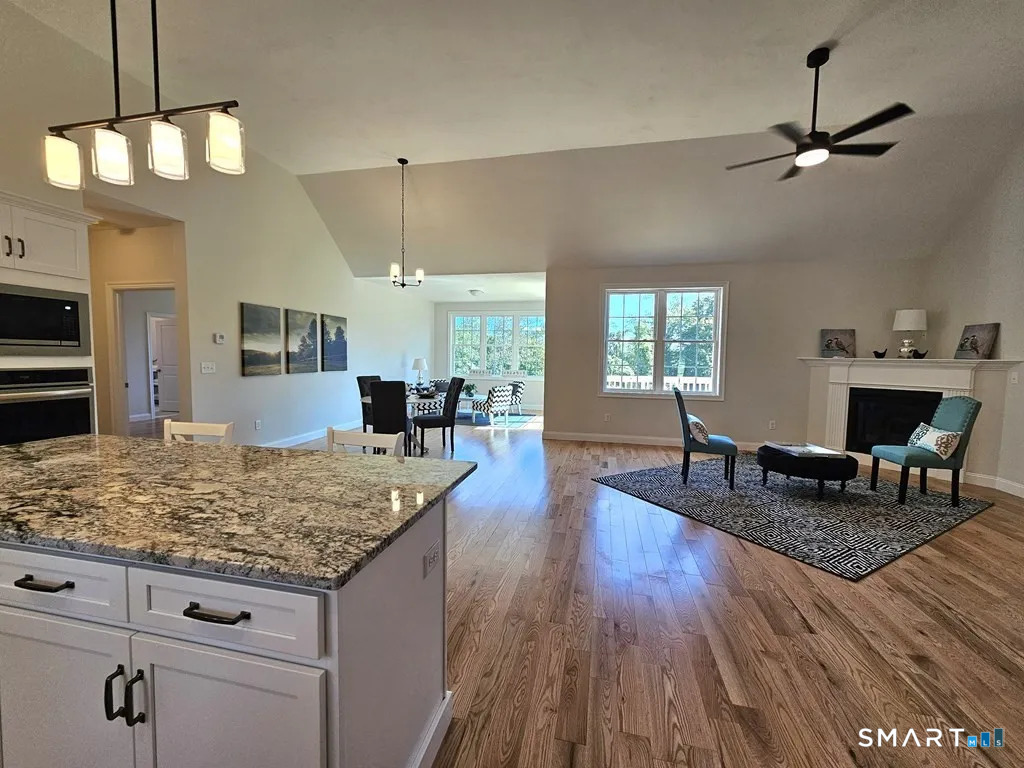 80 Aldrich Road Putnam, CT 06260 - Photo 4 of 23 a living room with fireplace furniture and a wooden floor