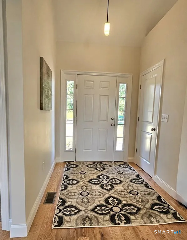 80 Aldrich Road Putnam, CT 06260 - Photo 10 of 23 a view of a hallway with wooden floor and a bathroom