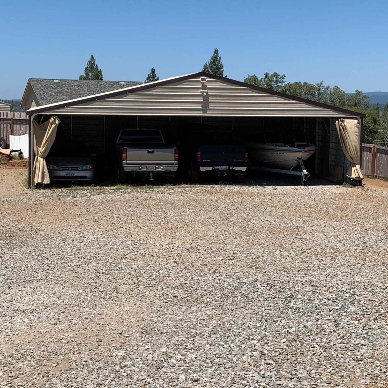 17958 Creations Way Mountain Ranch, CA 95245 - Photo 15 of 28 Four-space carport with storm curtains open for the summer.