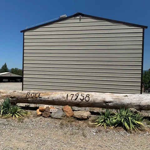 a view of a chairs and table in back yard